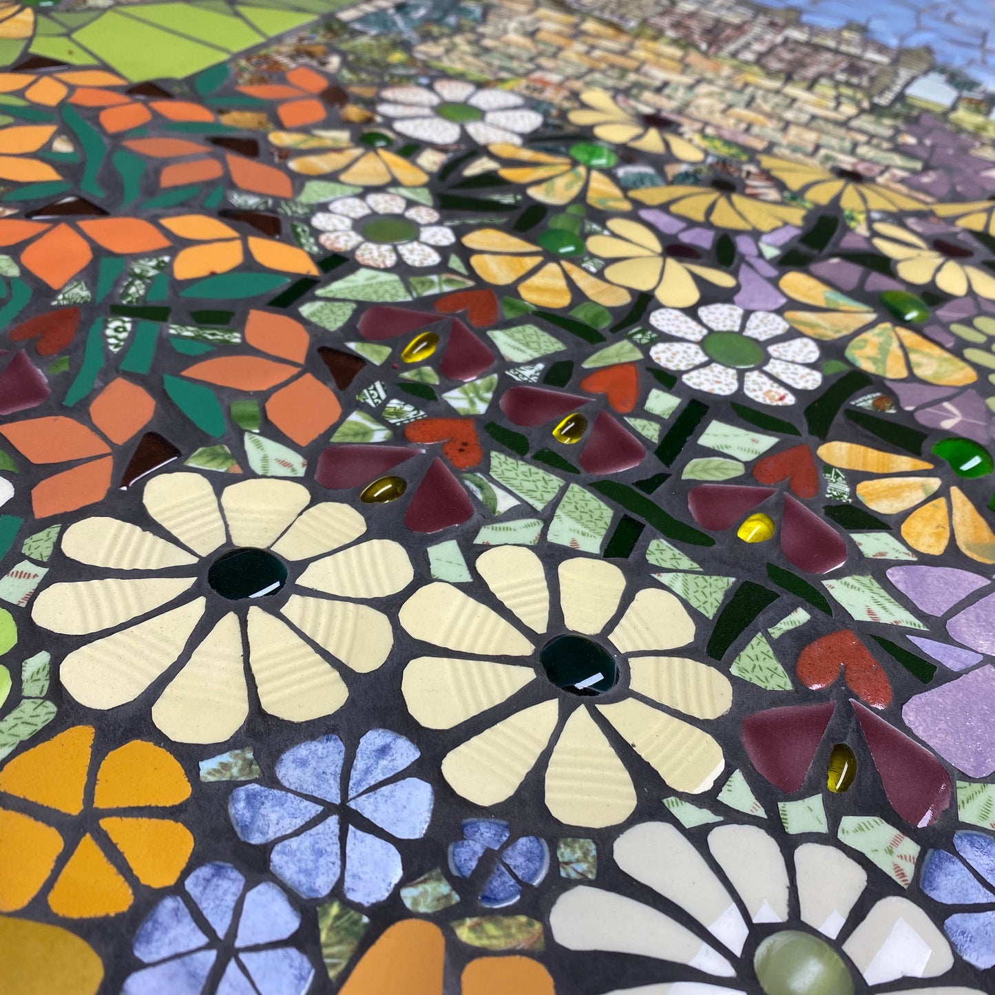A colourful mosaic garden using recycle tiles