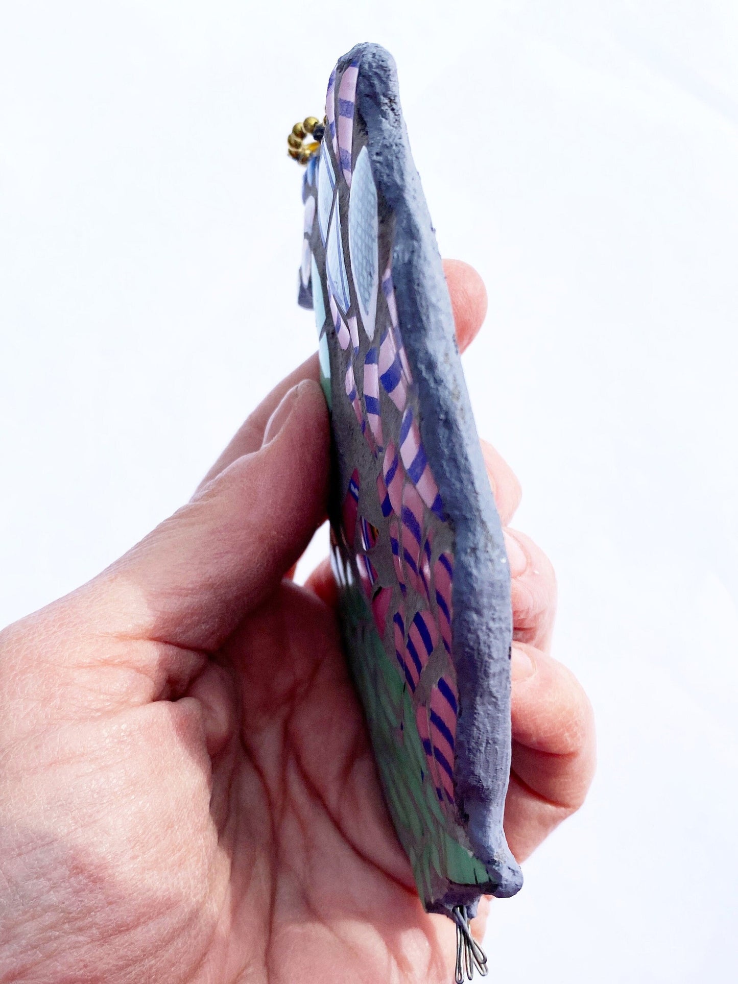 Mosaic peacock, Made from crockery. photographed held to show the depth of the mosaic