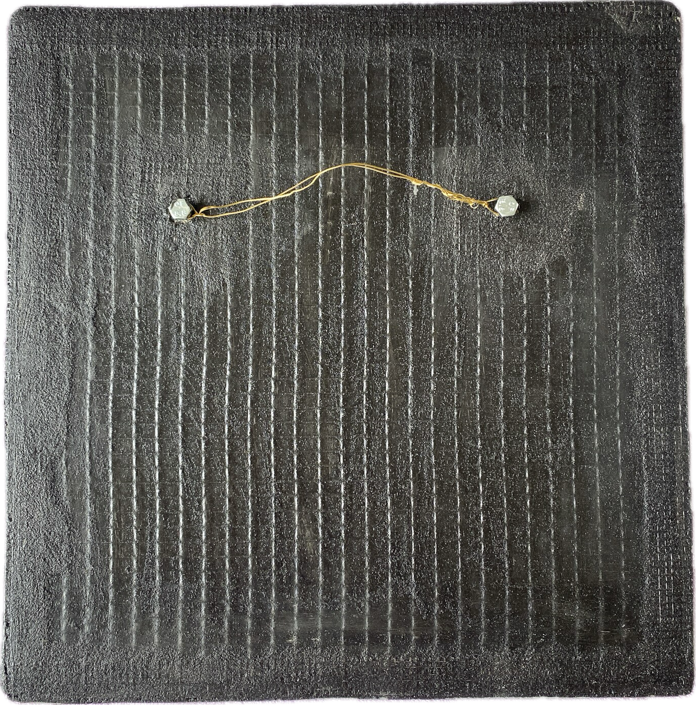 Reverse of a mosaic mirror, showing the Wedi board structure with the hanging mechanism - two bolts which come through the board, with hanging wire
