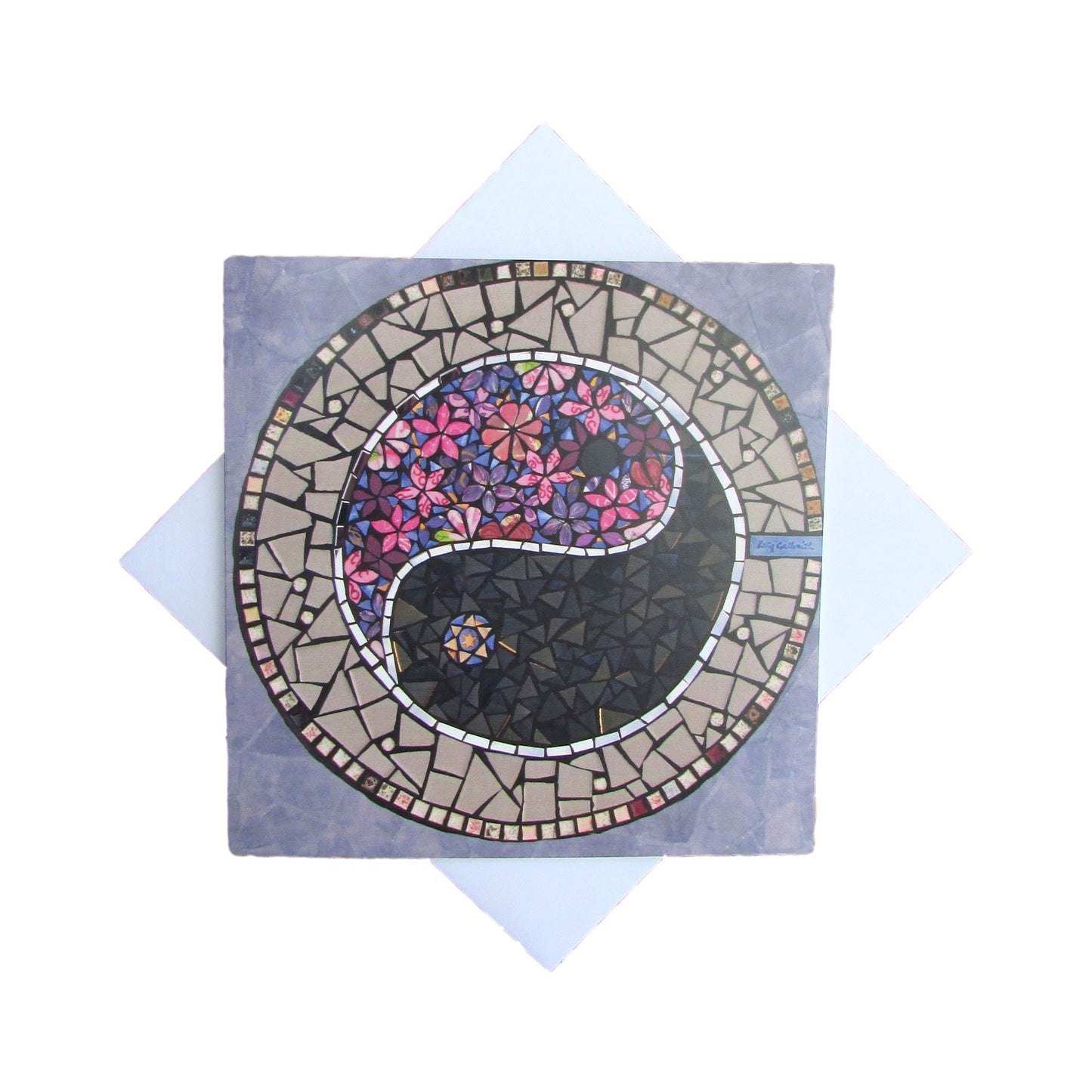 A pink and purple hued mosaic with a Ying Yang symbol. One half of it is in purple and pink flowers, and the other half is dark grey, with a ribbon of mirror. The ying yang circle is surrounded by purple, for this square card. photographed with a white background