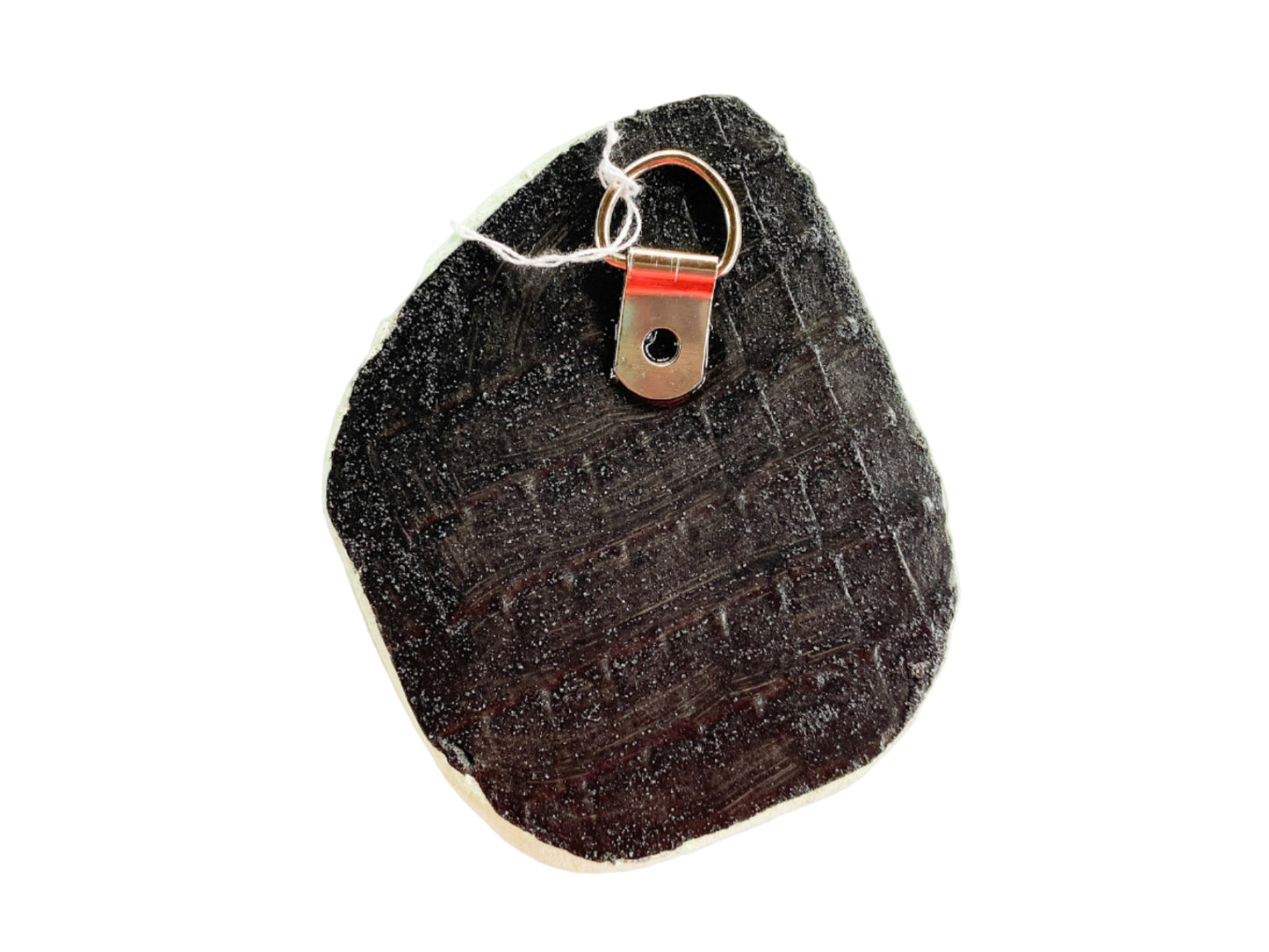 Black textured reverse side of mosaic with d-ring on a white background