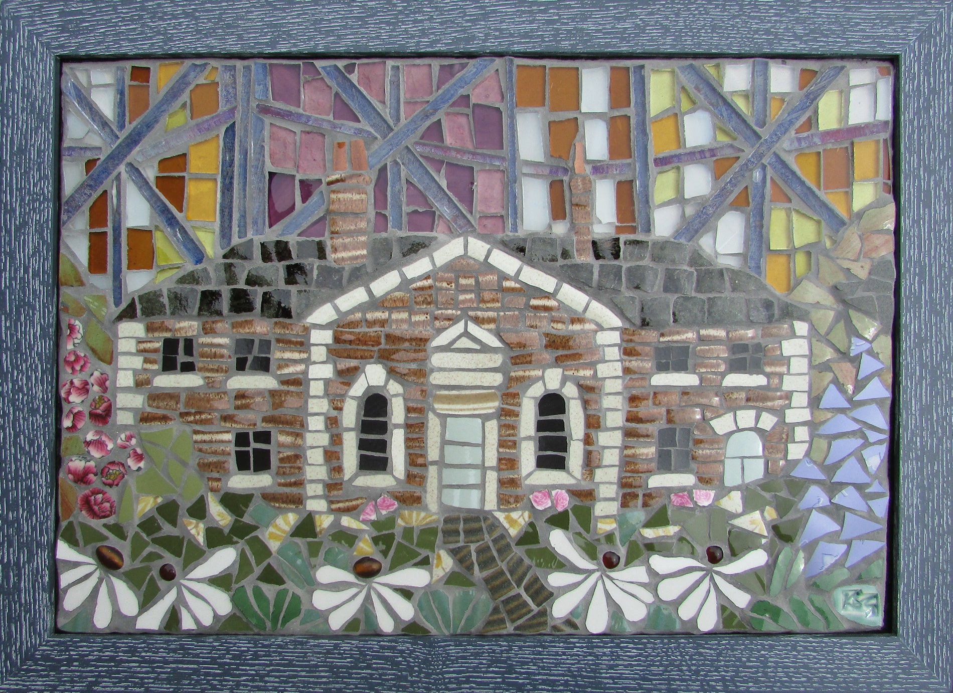 cottage in mosaic with flowers in the foreground and a colourful glass background