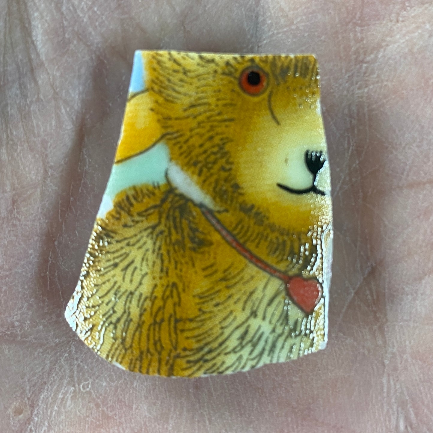 Decorative ceramic tile with a bear design on a beige surface