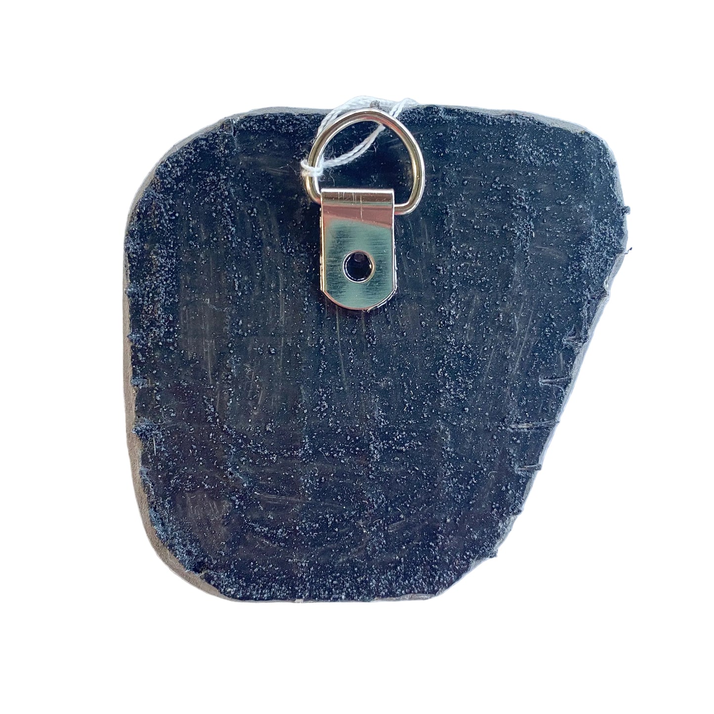 Black reverse side of a mosaic with a metal D-ring on a white background