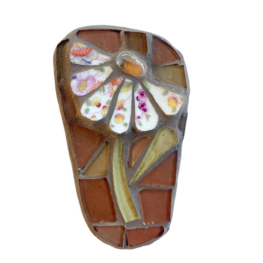 Mosaic art piece with a chintz flower design on a brown background