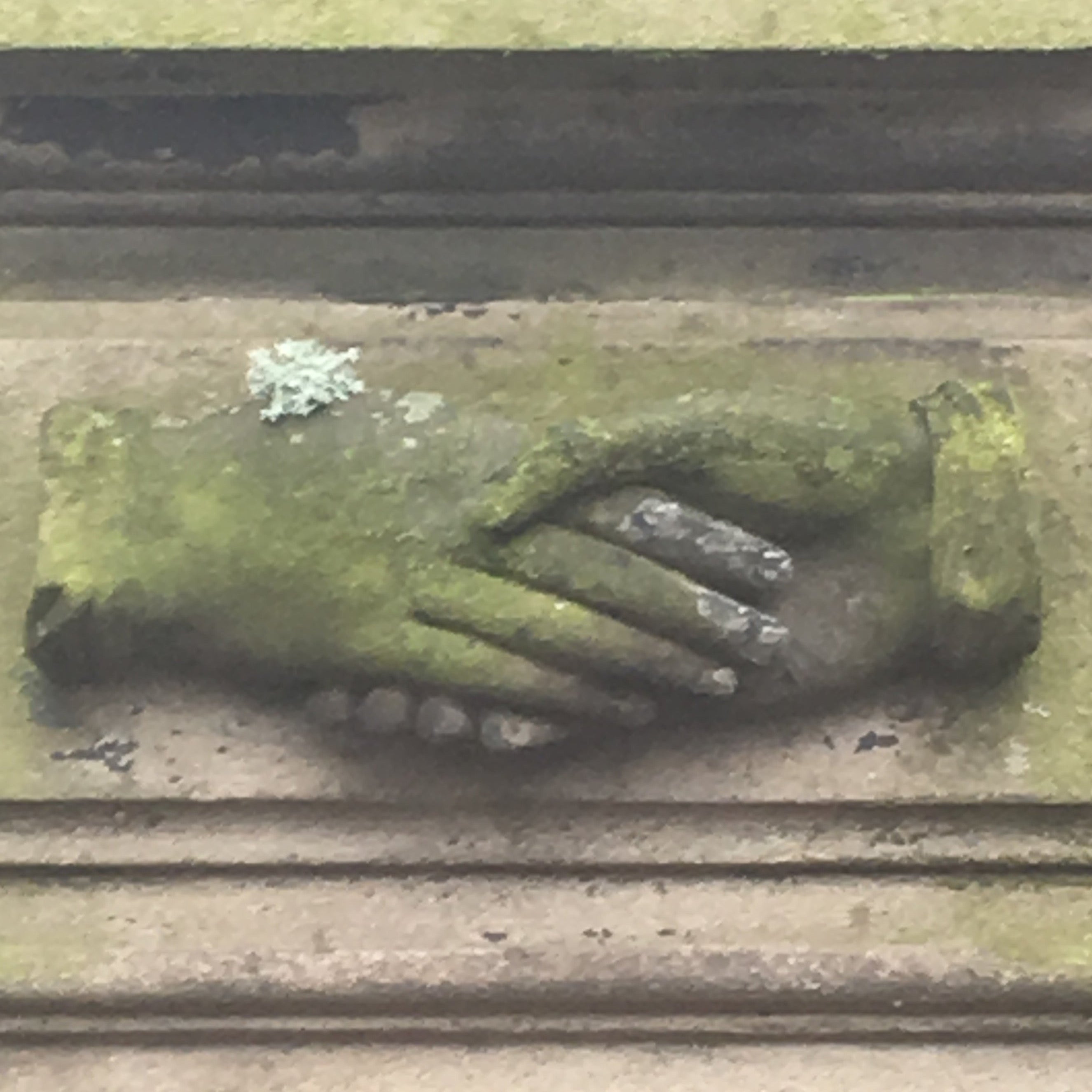 a carving of two hands holding each other