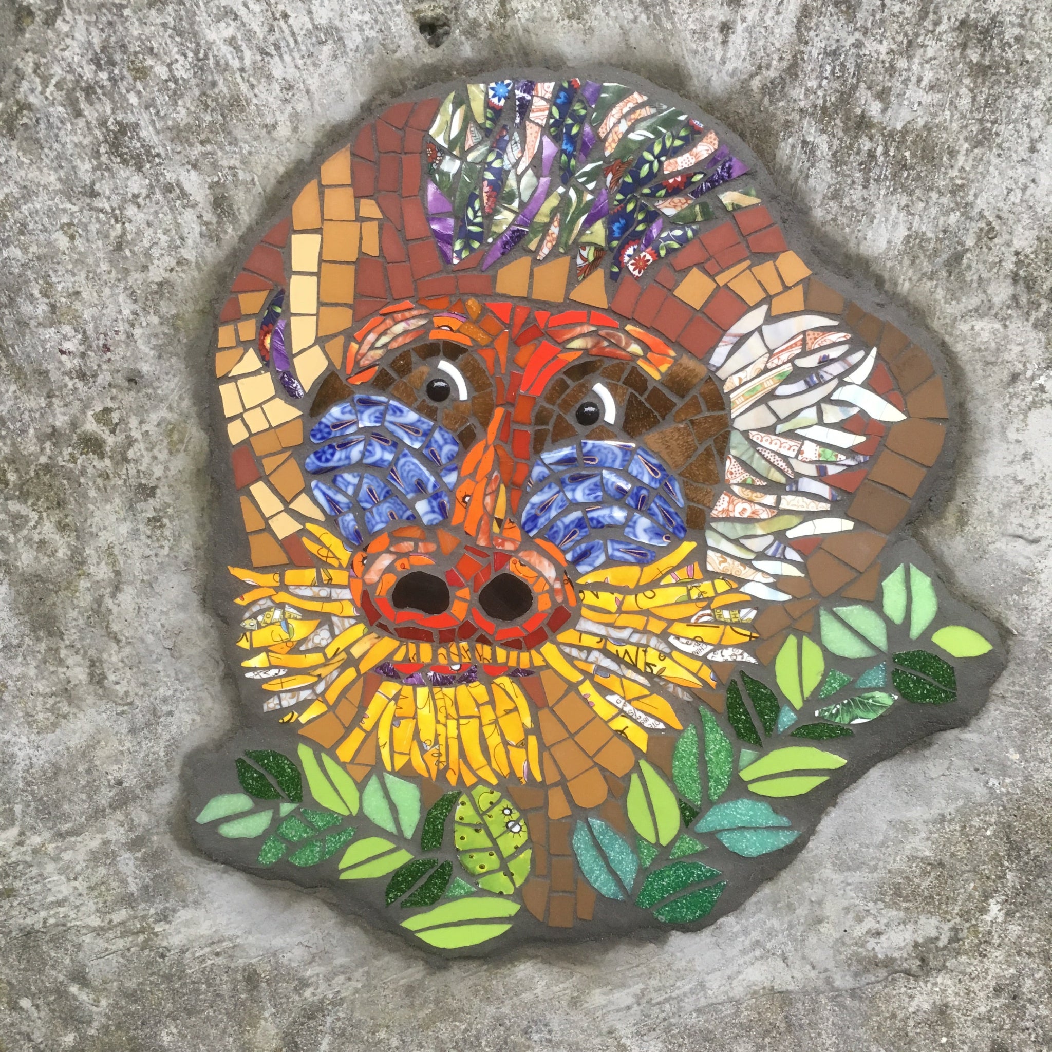 mosaic of a mandrill monkey made from recycled materials