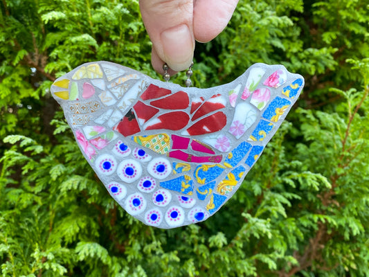 mosaic bird with blue dots at the breast, turquoise blue tail feathers and other bone china tesserae