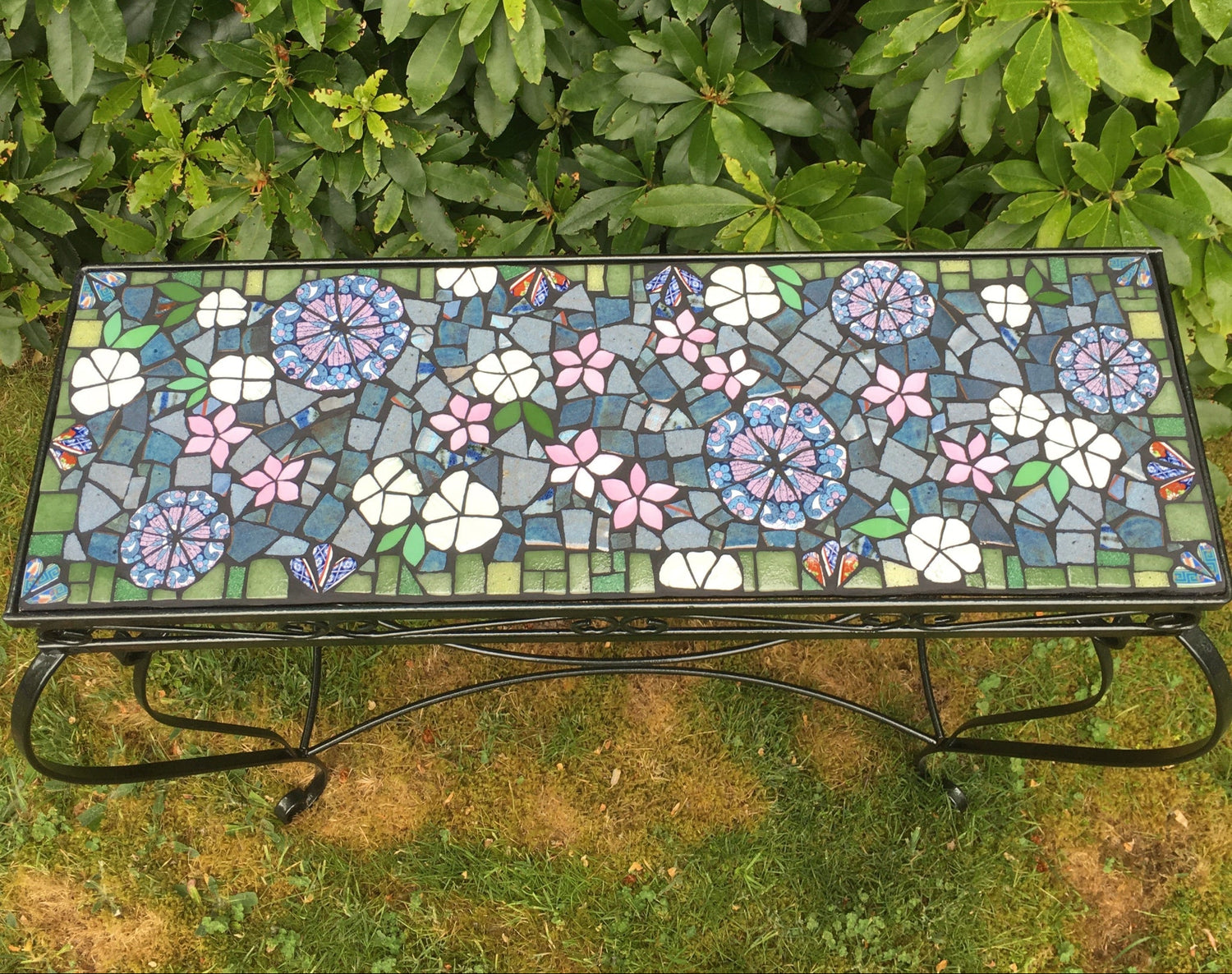 purple and pink flowers on this rectangular table in mosaic