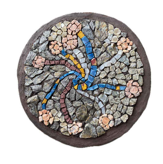 A circular mosaic made of various stones, with threads of blue and yellow plastic, and quartz representing stems, and pink toned stones for flower heads.  Brown painted edging.  Shown on a white background