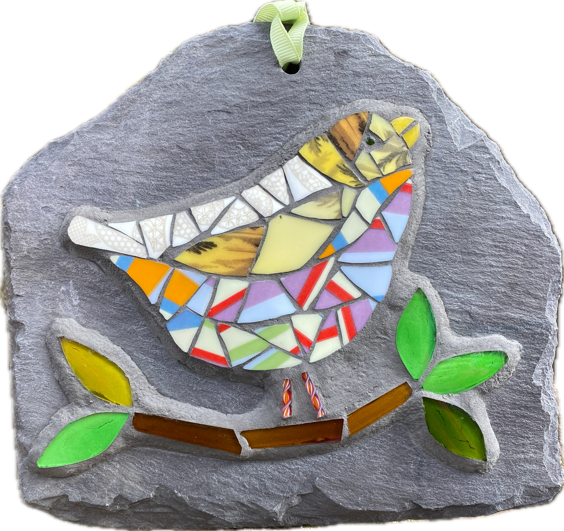 a colourful mosaic bird with lots of stripy tesserae with a branch and leaves in glass on a grey slate. photographed on white background