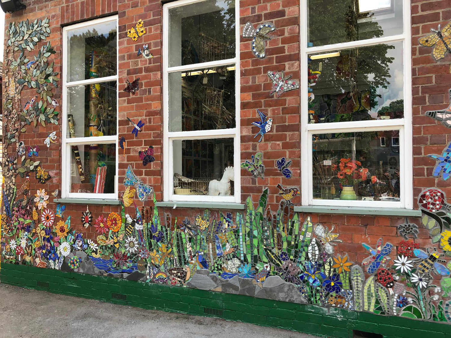 mosaic garden on a red brick wall