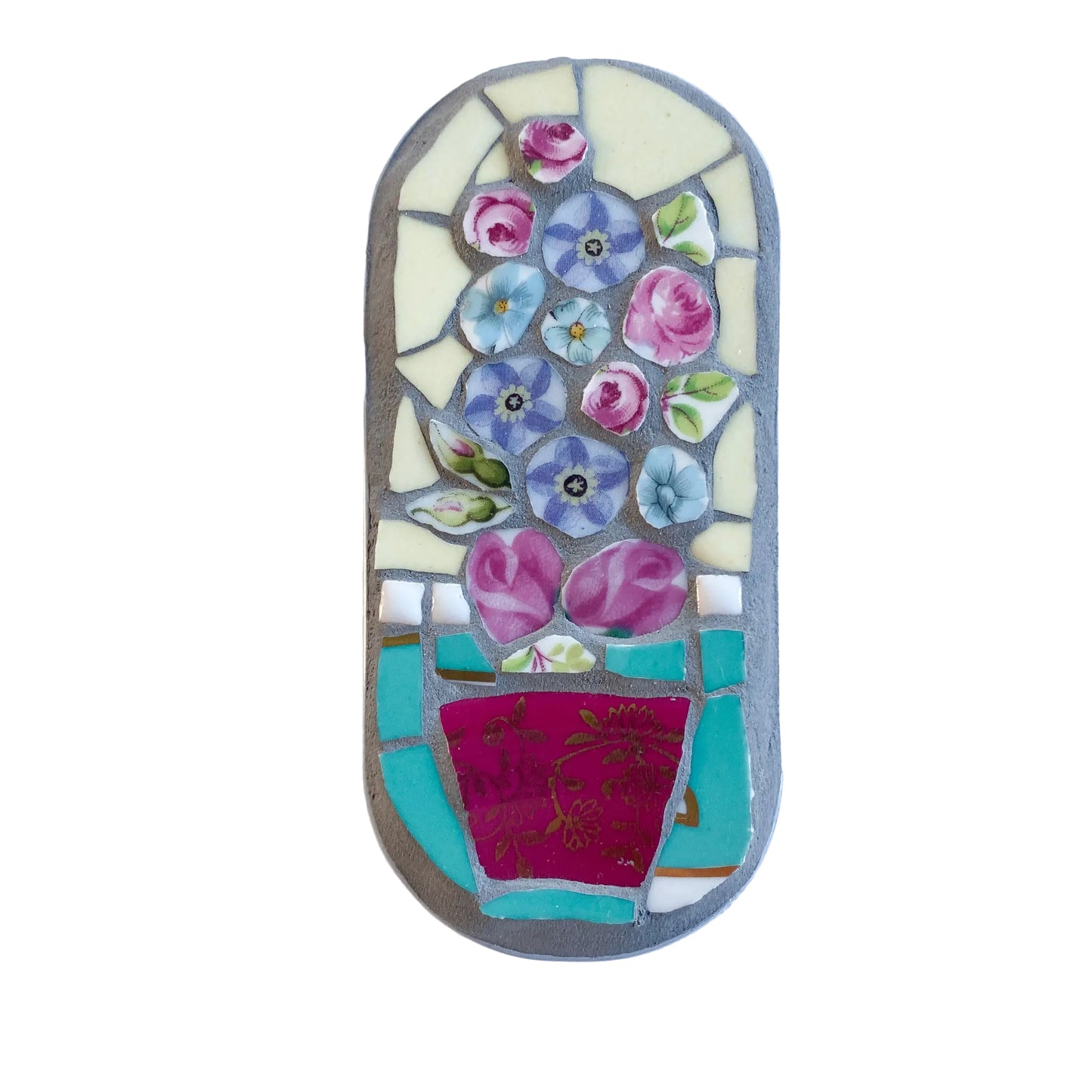 Mosaic art piece in an anchovy tin with floral design on a  white background