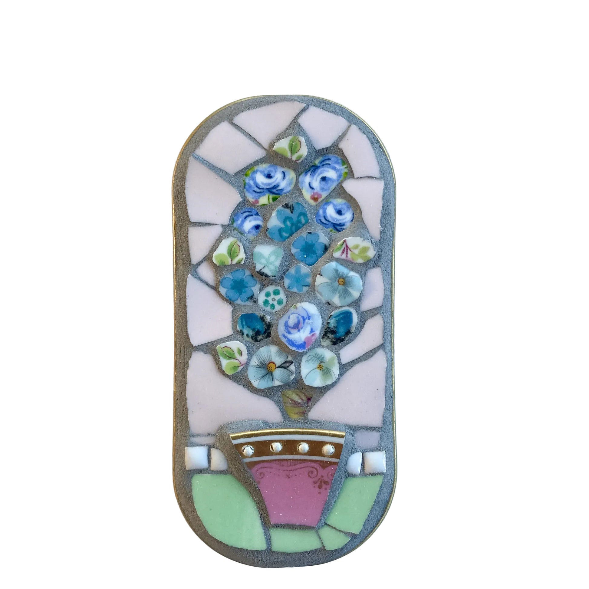 Mosaic art piece in an anchovy tin with floral design on a  white background
