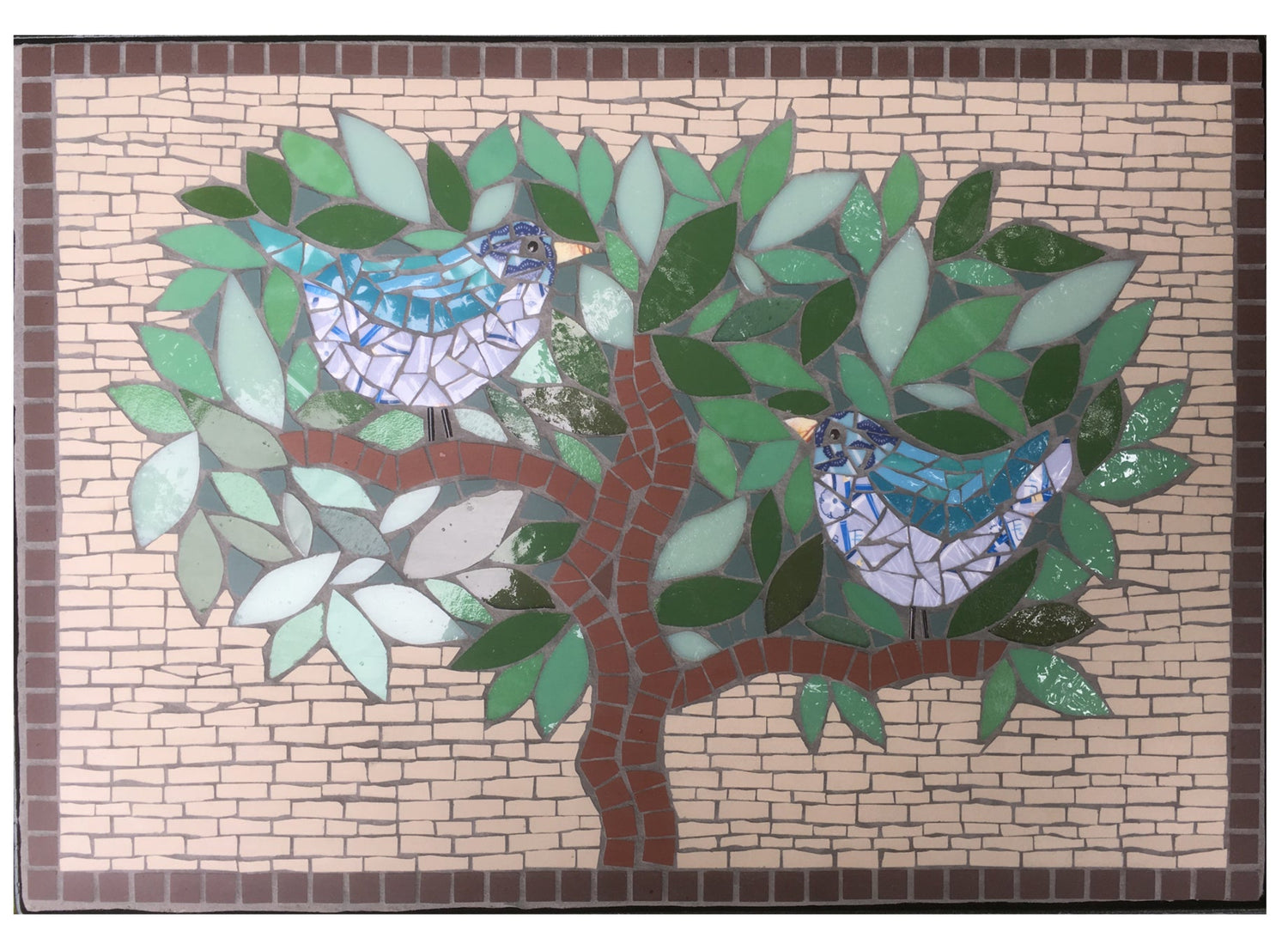 mosaic tabletop with two turquoise in a tree