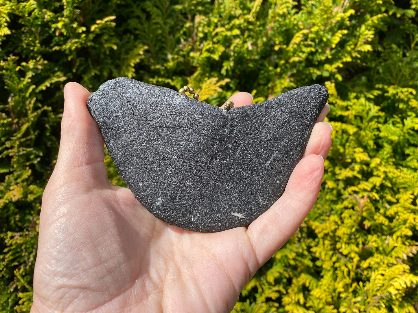 reverse of a mosaic bird showing the cement structure, handheld.  
