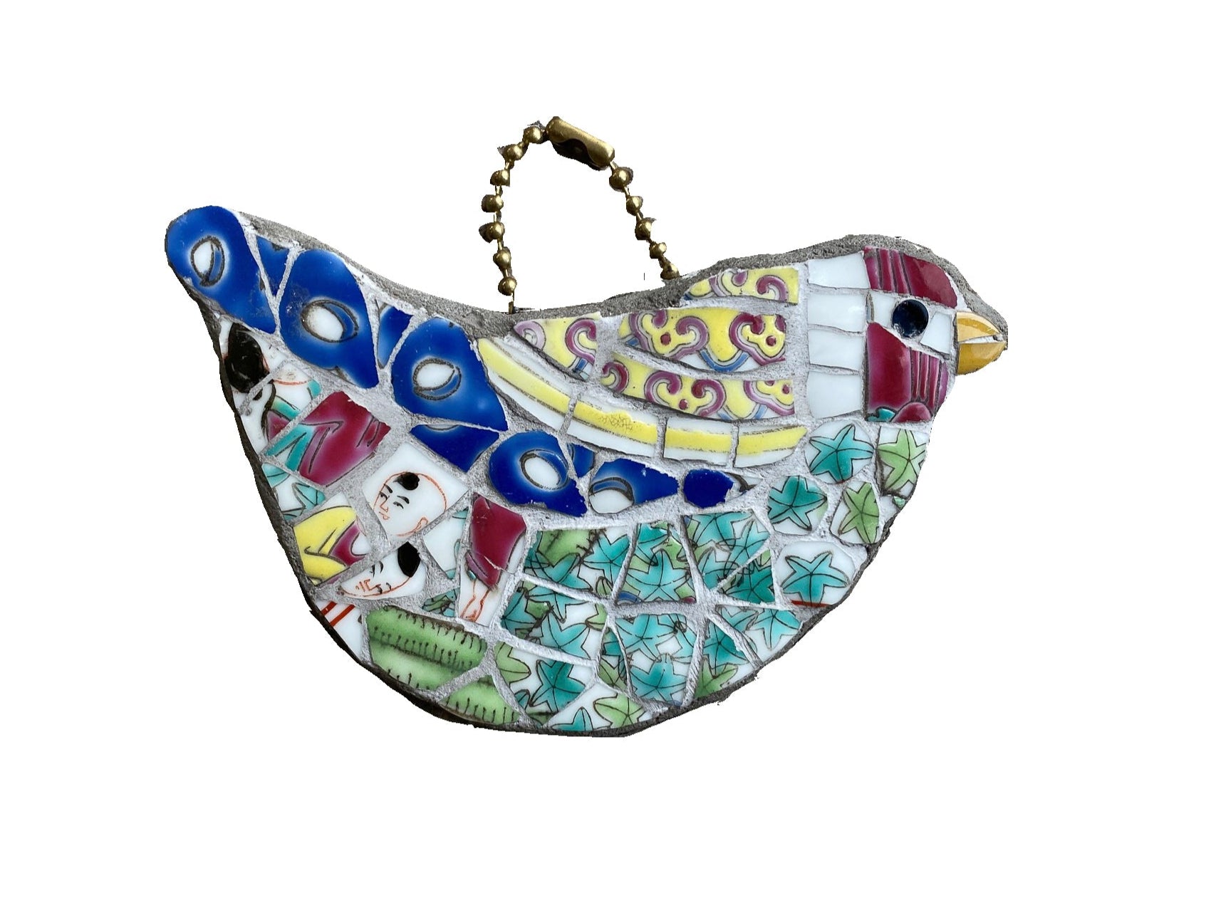 a multicoloured bird mosaic which hangs from a ball chain loop, with a red head, green body and blue feathers, all made from a chinese porcelain pot. photographed on a white background