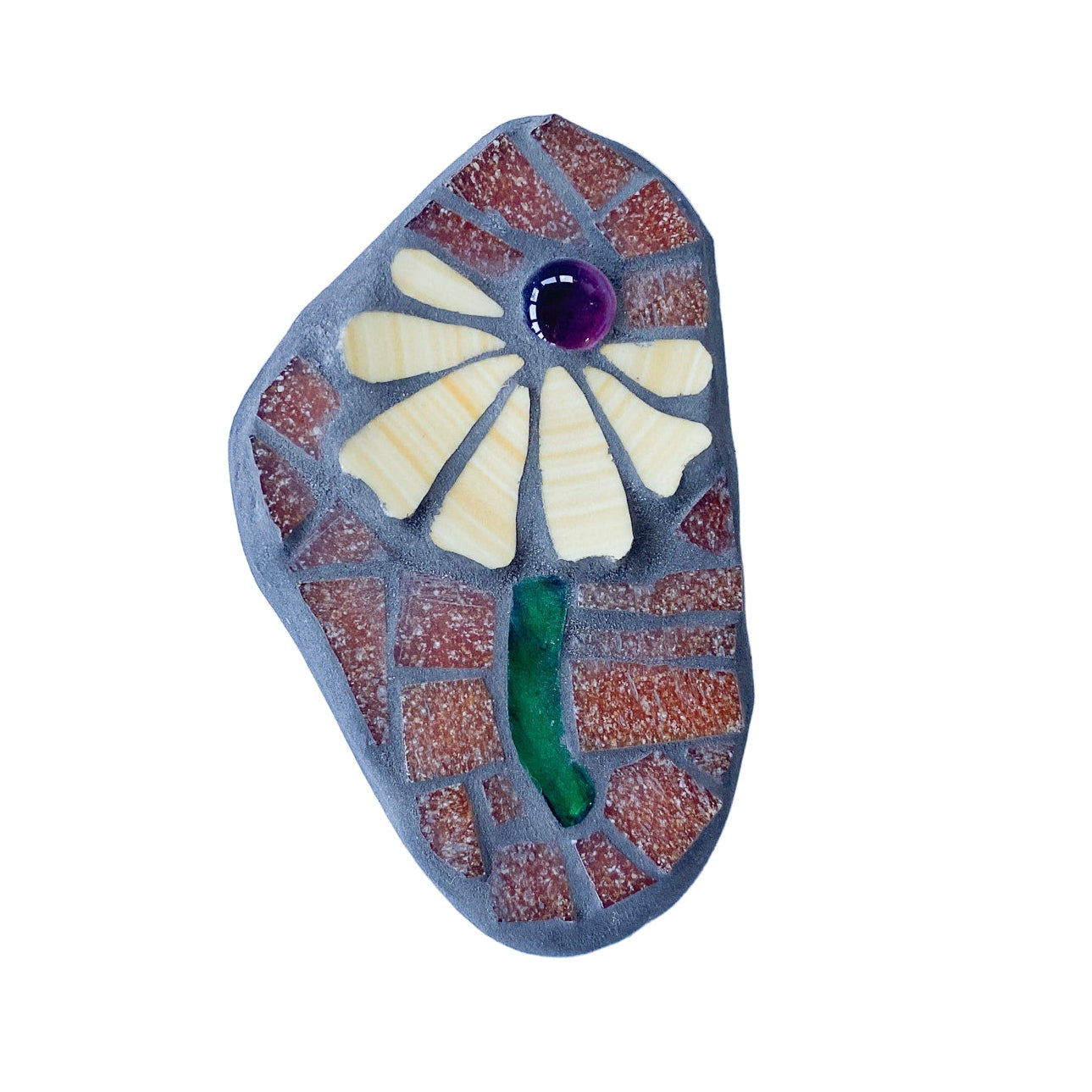 Decorative mosaic with a yellow floral design on a brown tile background, photographed on white