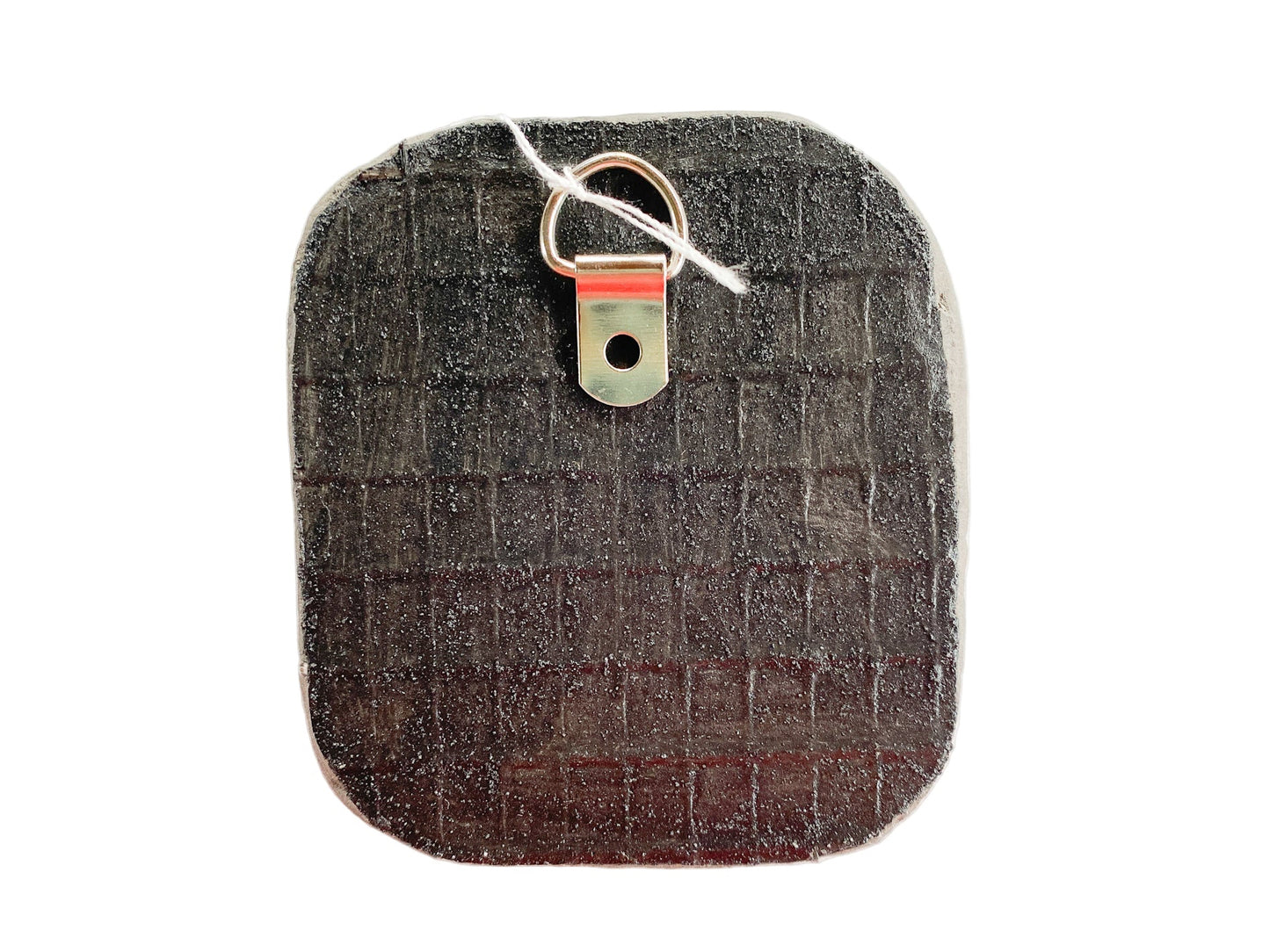 Textured reverse side of mosaic with d-ring on a white background