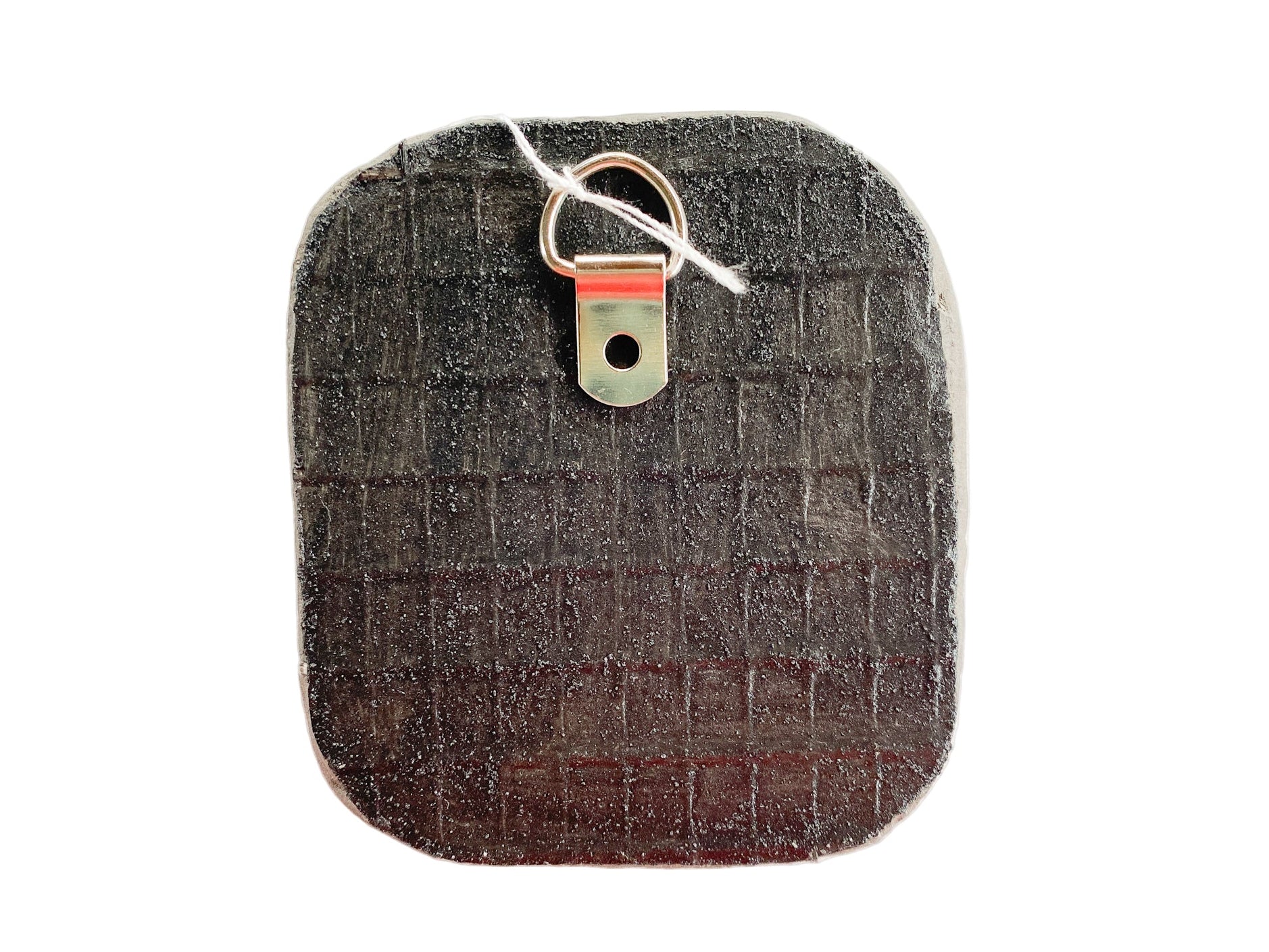 Textured reverse side of mosaic with d-ring on a white background