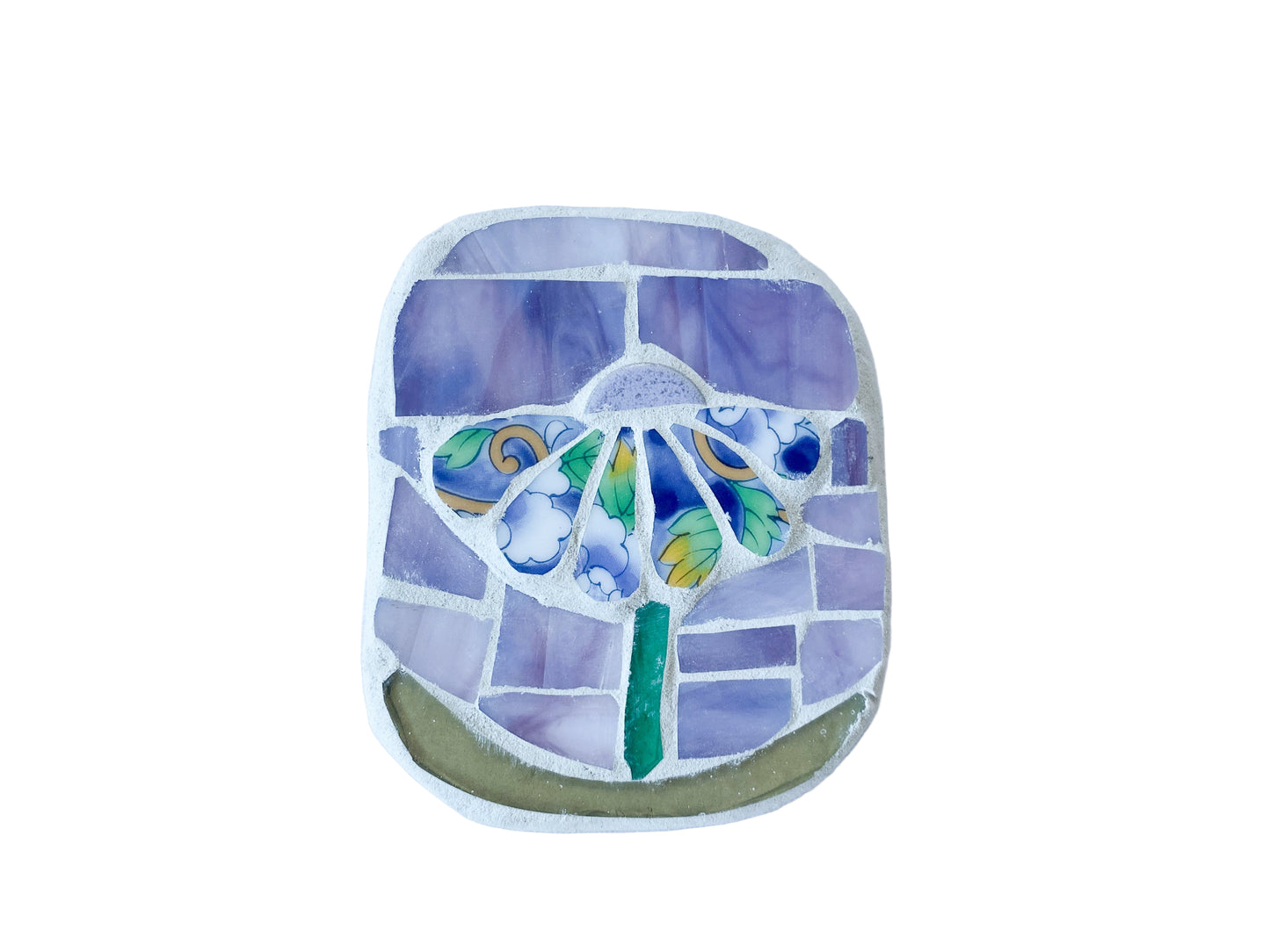 Decorative mosaic with patterned floral design on a lilac background, photographed on white 