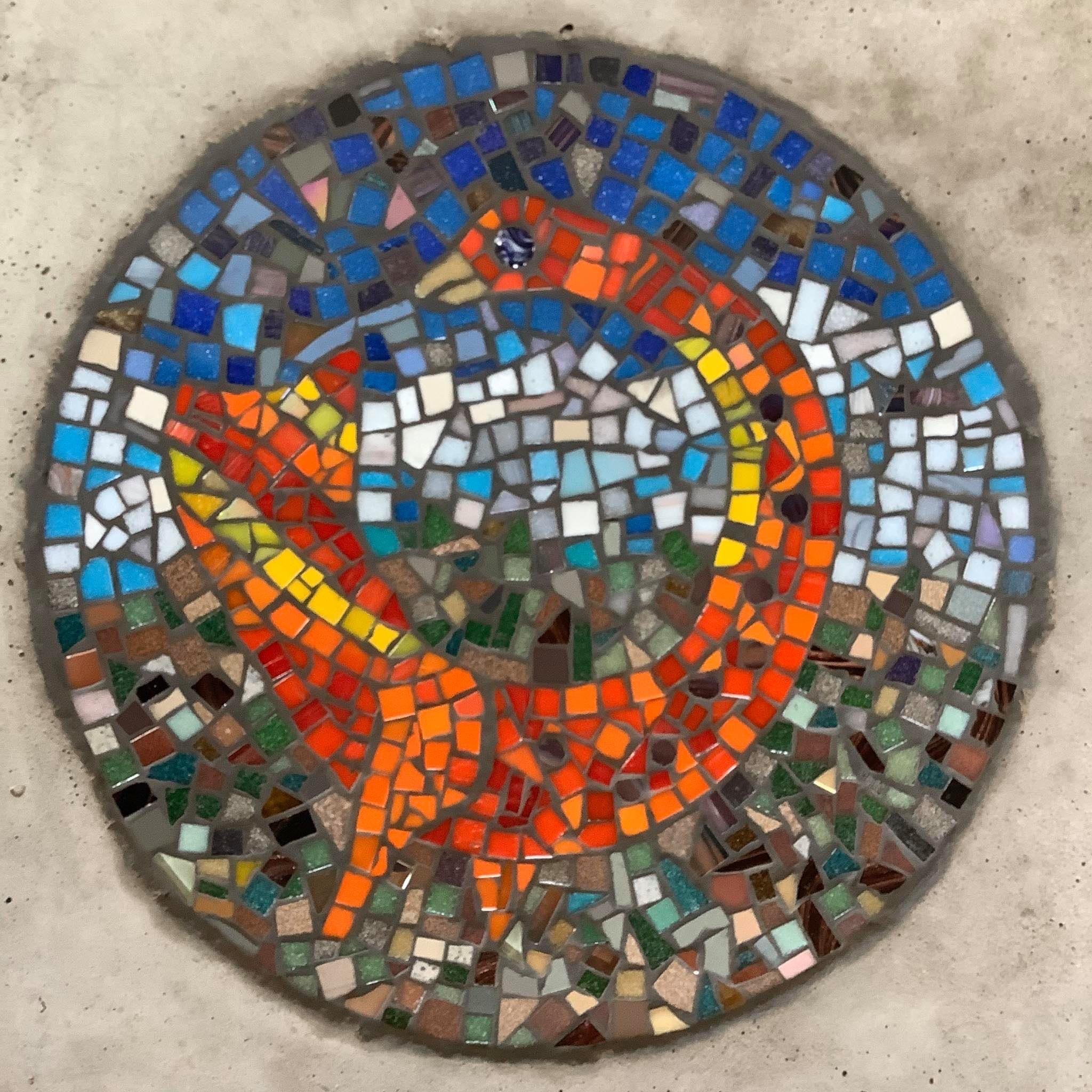 mosaic circle of a red and orange stylised goose with a loose representation of a landscape